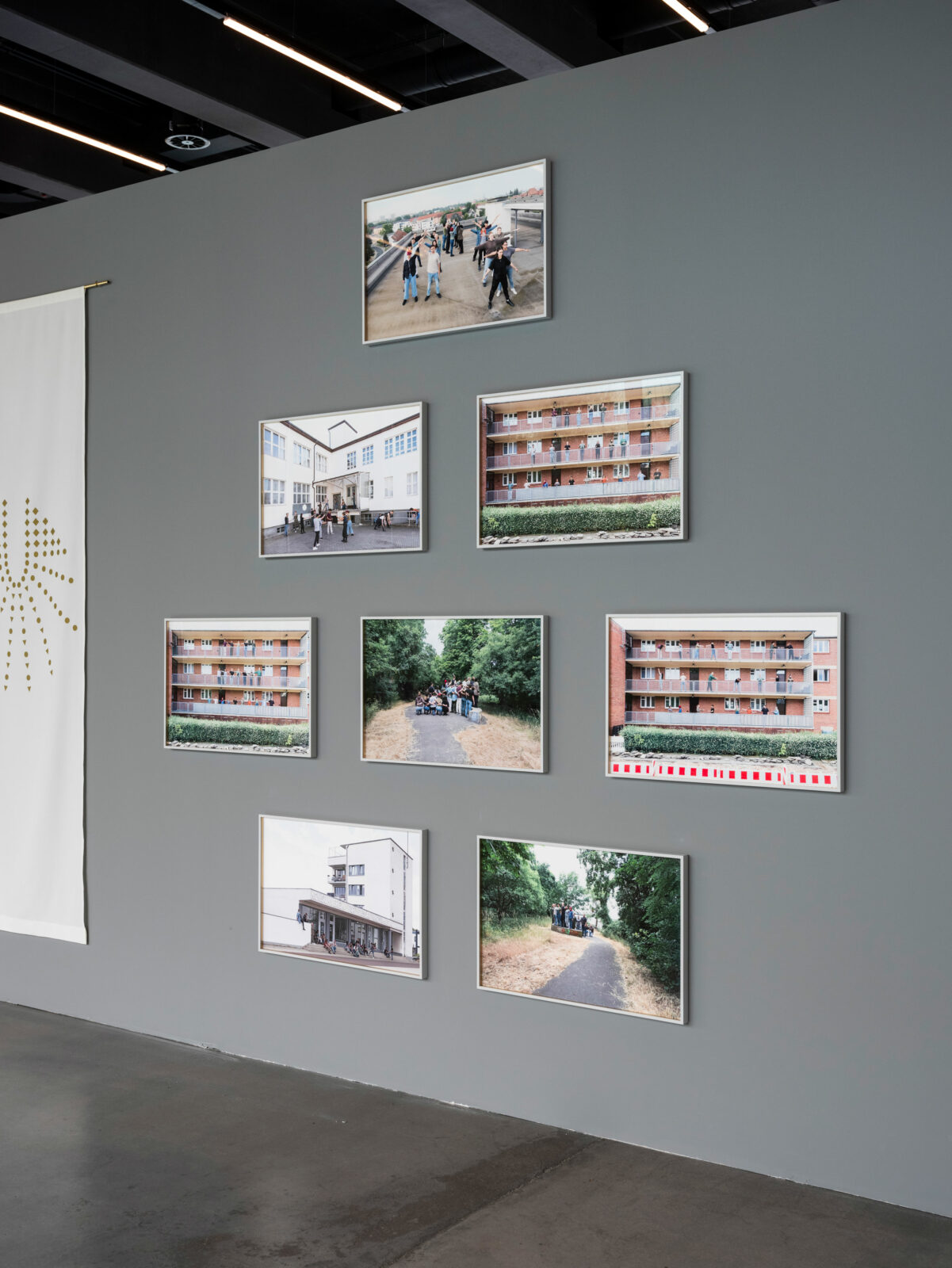 Detailed view of the photo prints by Christina Werner. They show groups of people at various locations in Dessau. 